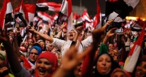 Egyptian protesters cheer in Tahrir Square in Cairo, Egypt, after the Egyptian military ousted President Mohammed Morsi in a coup, July 3, 2013. (Suhaib Salem/Reuters)